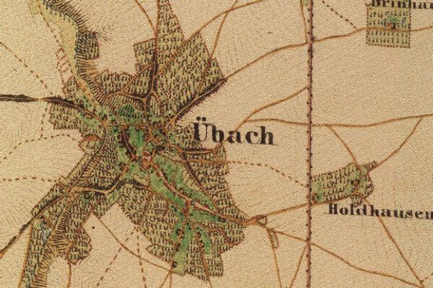 Ein detailliertes altes Stadtplan von Ubach, Deutschland, der Straßen, Gebäude und Sehenswürdigkeiten mit Textanmerkungen zeigt.