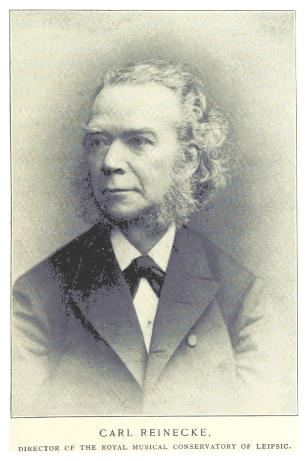 Schwarzes und weißes Foto von Carl Reinecke, dem Direktor des Königlichen Musikalischen Konservatoriums Leipzig, der einen Anzug trägt, mit Text unten im Bild.