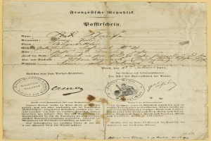 Alter deutscher Regierungsdokument mit einem runden, schwarz umrandeten Stempel auf vergilbtem Papier, geschrieben in schwarzer Tinte.